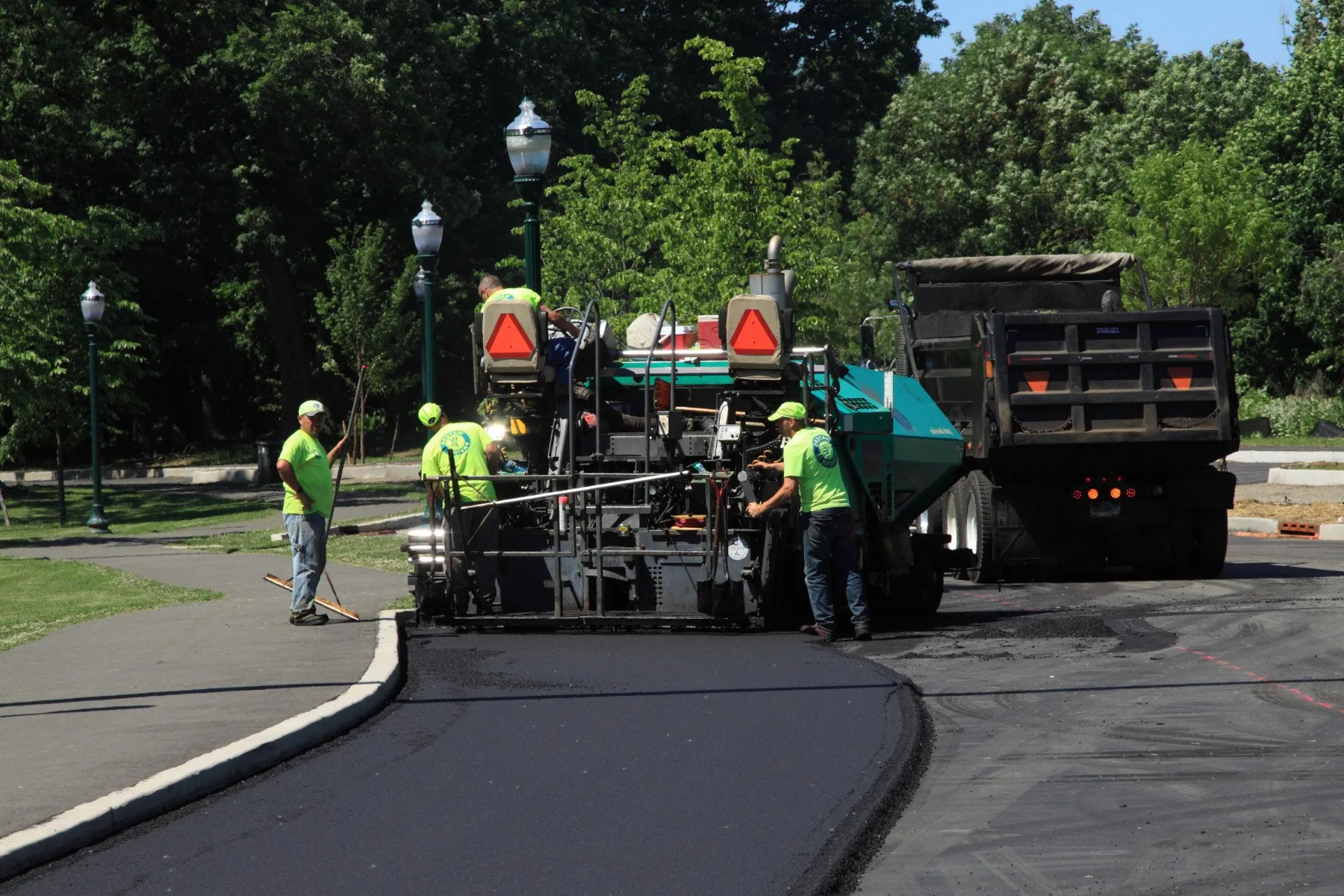 This new asphalt top layer helps restore the surface's prior appearance and increase the private road's curb appeal.