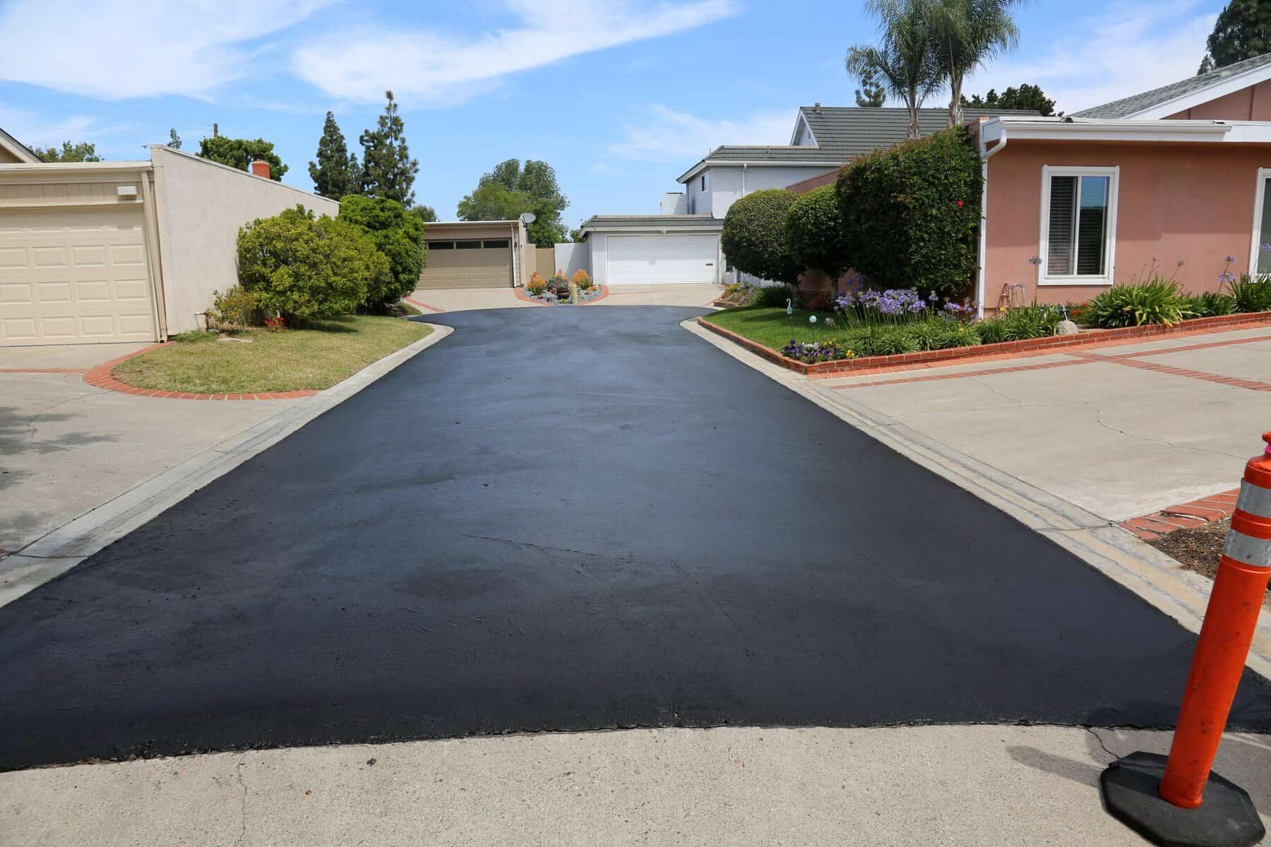 The homeowners are protecting their driveway from the sun, water, and chemicals by sealcoating it.